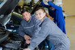 © auremar - portrait of a young female trainee auto-mechanic with her supervisor
