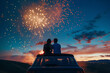 © fotogurmespb - Wide angle of couple watching fireworks, sitting on car roof, night sky filled with color