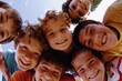 © Inigo - Group of kids smiling and looking at the camera in a low angle view