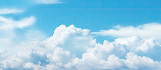 Poster - In spring a serene copy space image reveals a pale blue sky adorned with picturesque white fluffy clouds