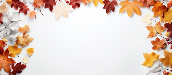 Leinwandbilder - Autumn leaves surround a white square frame creating a picturesque copy space image