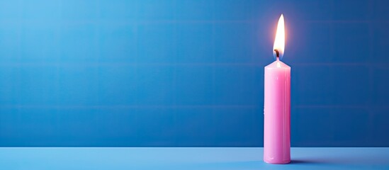 Sticker - A pink birthday candle with the number 0 is seen burning on a blue backdrop creating a copy space image