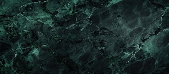 A grunge dark background featuring an abstract black and green marble texture with copy space image