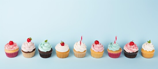 Aufkleber - A flat lay composition featuring cupcakes on a light blue background with room for text perfect for a birthday party. Creative banner. Copyspace image