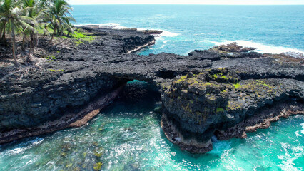 stunning cliff face featuring a bridge between two rocky outcrops, Sao Tome, Africa