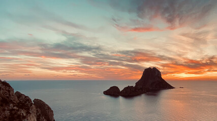 Aerial view of romantic sunset over the sea and a rock in Es Vedra, Ibiza, Spain