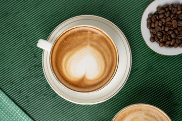 Wall Mural - Steaming cup of cappuccino topped with foam