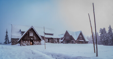 Poster - Rustic wooden cabin with snow-covered terrain in Crater Lake National Park. Oregon, USA