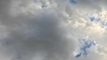 Wall Mural - Time-lapse low angle footage of white dense clouds moving in the blue sky on a sunny day