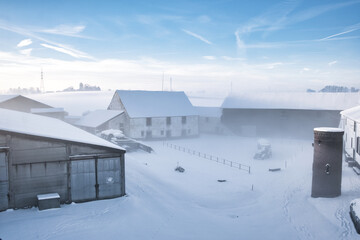 Poster - Icy farm with snow on the ground and a barn in the background