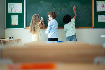 Before beginning their academic day, Children like writing on the chalkboard.