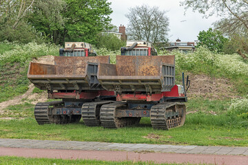 two mini trucks with a steel loading platform on steel tracks