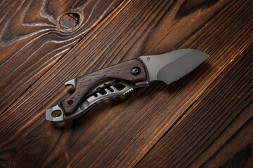 Wall Mural - Tactical knife on a wooden background