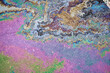 © AleksFil - Colorful texture of spilled petrol oil on wet pavement.