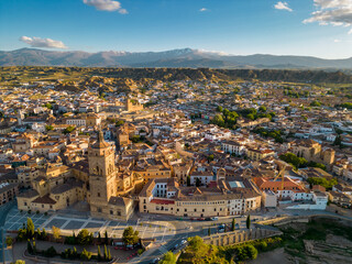 Aerial drone view of Guadix city. Historic and medieval city of Guadix lies at an altitude of 913 metres. In background is Sierra Nevada Mountain, with snow on peaks. Sunset. Sunset point. 