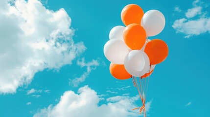 Wall Mural - White and orange balloons with clouds and blue sky background ,Defocused background of colorful helium balloons isolated on background, Intentionally blurred post production for bokeh effect
