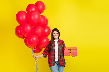 Wall Mural - Photo of shiny attractive lady dressed checkered shirt holding birthday gifts empty space isolated yellow color background