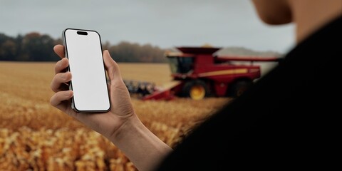 Hand holding a phone with a against a farm bg, for agriculture-related mockups