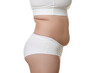 © New Africa - Woman with excessive belly fat on white background, closeup. Overweight problem