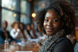 © AI_images_for_people - African American businesswoman leading diverse team in boardroom.