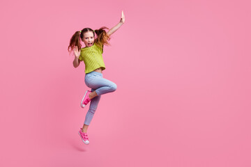 Poster - Full length photo of lovely little girl dancing have fun dressed stylish green garment isolated on pink color background