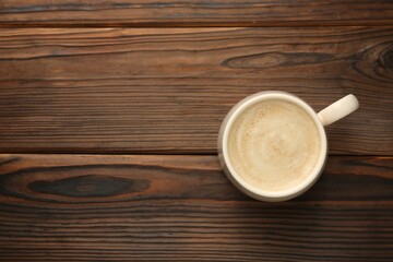 Wall Mural - Cup of coffee on wooden table, top view. Space for text