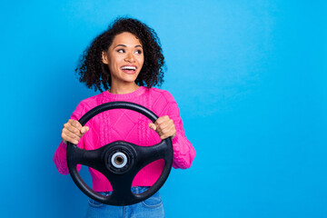 Wall Mural - Photo of charming dreamy lady wear pink sweater riding car looking empty space isolated blue color background