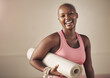 © peopleimages.com - Laugh, black woman and mat for portrait, yoga and ready for spiritual awareness exercise. Female person, self care and equipment for pilates or relax in studio, mindfulness and gear for activity