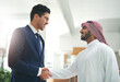 © peopleimages.com - Arab, business and people with hand shake in office, recruitment and muslim employee for greeting. B2b partnership, collaboration and congratulation gesture for deal, islam company and onboarding