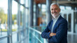 © mattegg - Senior Businessman Standing in Front of Glass Wall