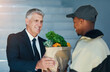 © peopleimages.com - Smile, happy customer and delivery man at door with groceries for online shopping bag, home and distribution. Supermarket service, food package and courier with sale of fresh vegetables at house.