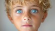 © Multiverse - A young boy with blue eyes staring directly at the camera