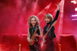 © Maria Moroz - Two young children playing music together, one on a saxophone and the other on a guitar.