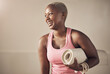 © peopleimages.com - Yoga, black woman and mat for fitness, thinking and ready for exercise or workout. Female person, self care and equipment for pilates or practice in studio, laughing and yogi mala beads for peace