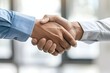 © Odin AI - This stock image shows a close-up of a handshake between two people in a professional setting, symbolizing agreement or greeting