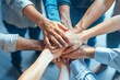 © Odin AI - Corporate team members joining hands together in a show of unity and cooperation, with a focus on the touching hands