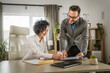 © Miljan Živković - Mature woman sign insurance or contract to her colleague at office