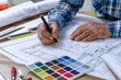 © DWN Media - Designer is drawing blueprints for an architectural project, surrounded by color swatches and sketches of the building's design elements.
