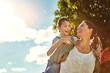© peopleimages.com - Mom, child and piggyback by sky with space for mockup with love, sunshine and memory on holiday. Family, mother and daughter with smile, carrying and game on adventure by clouds in garden on vacation