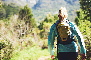 Wall Mural - Back, walking and woman hiking on trail in nature on outdoor adventure to explore on holiday vacation. Girl, runner and hiker trekking in woods for training, wellness or travel journey for fitness