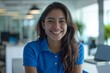 © Лена Шевчук - A young mexican community manager wearing a blue polo shirt in a white office, laugh