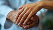 © fourtakig - A Compassionate Doctor A close-up shot of a doctor's hands gently holding a patient's hand, conveying empathy and care