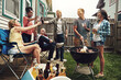 © peopleimages.com - Friends, cheers and beer in backyard with bbq for social event, party or celebration with talking in home. People, drinking alcohol and toast with relax, conversation or diversity at barbecue reunion