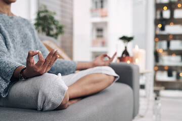 Poster - Mudra, hand and meditation on sofa in home for chakra connection, balance and mental health in morning. House, peace and zen person with spiritual healing for holistic, mindfulness and awareness