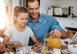 © peopleimages.com - Happy, girl and dad together with breakfast on table for nutrition, eating or sharing. Hungry, man and kid in home excited for meal, drink and wellness on social morning with healthy food and juice