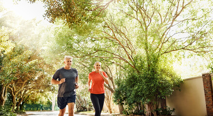 Wall Mural - Mature, couple and road running for outdoor workout or healthy partnership, morning or wellness. Man, woman and fitness together for sports recovery or bonding with park jogging, marriage or nature