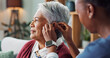 © peopleimages.com - Nurse, woman and hearing aid on ear for medical support, wellness and innovation of disability. People, healthcare worker and deaf patient with audiology implant, service or help for sound waves
