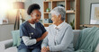 © peopleimages.com - Happy face, nurse and elderly patient in nursing home for healthcare and volunteer with charity on sofa. Clinic caregiver, portrait and embrace a senior lady with trust and medical support on couch