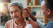 © peopleimages.com - Nurse, patient and hearing aid on ear for medical support, wellness or innovation of disability. People, healthcare worker or deaf man with audiology implant, check and service or help for sound wave