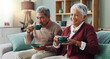 © peopleimages.com - Senior couple, happy and coffee on sofa in house, home and living room for retirement. People, elderly partners and family drinking tea, laughing and relax on couch for love, bonding and affection